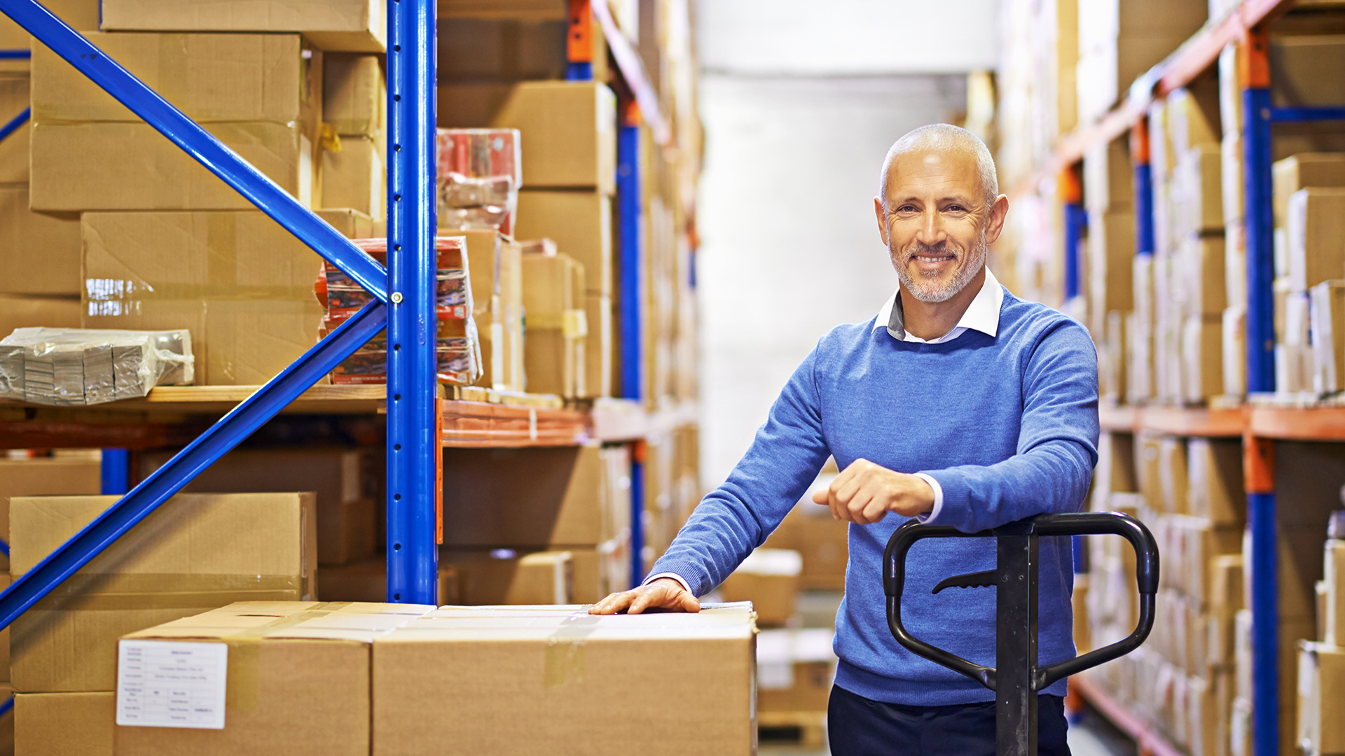 Smiling man in a warehouse