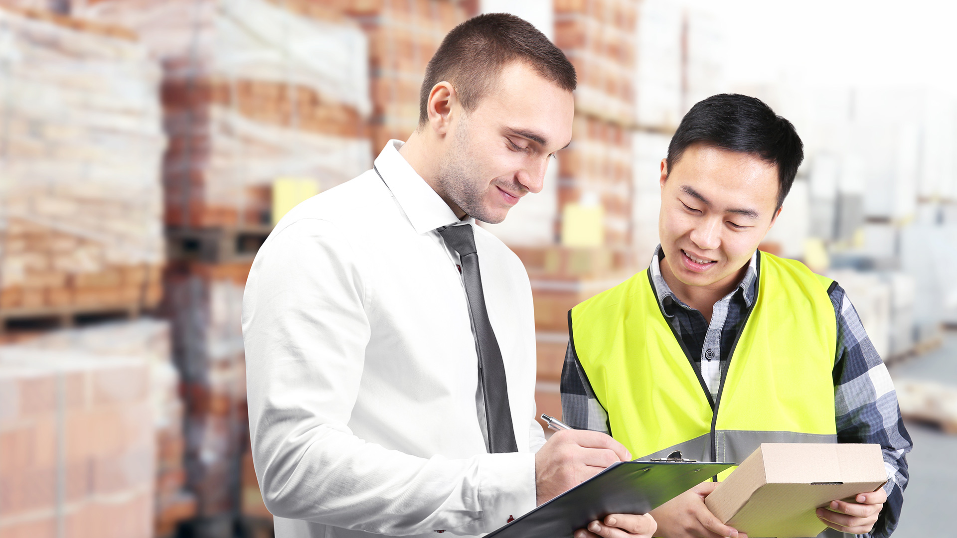 Warehouse worker and businessman collaborating
