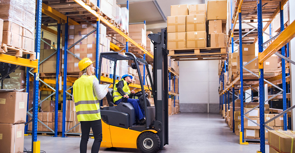 Man driving forklift at distribution center