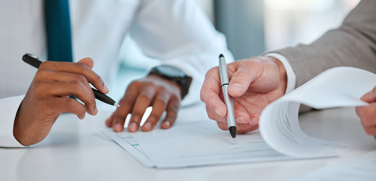 Saving time and money with annual pricing agreements - two men signing agreement